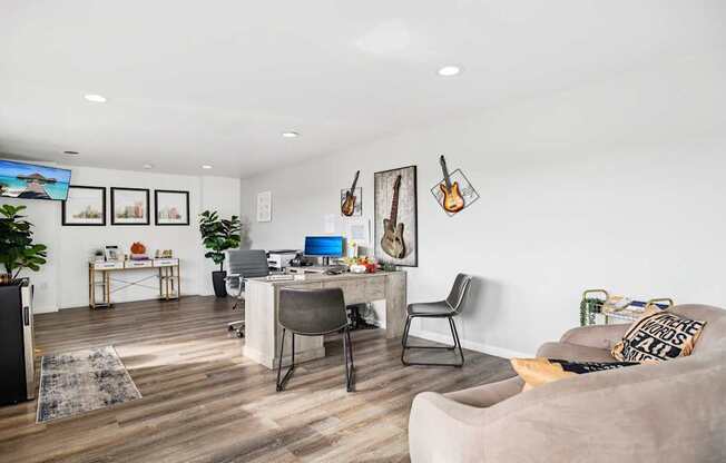 A modern living room with a grey couch and a TV mounted on the wall.