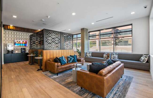 A modern living room with a wooden floor and a large window.