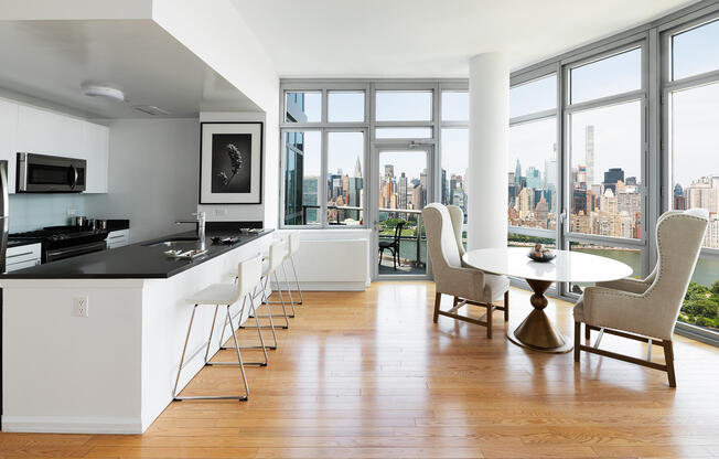 Modern kitchen and dining room overlooking Midtown Manhattan and the East River. 