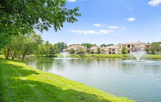 A serene lake with a fountain at Stonepost Lakeside Apartment Homes, Kansas, 66062