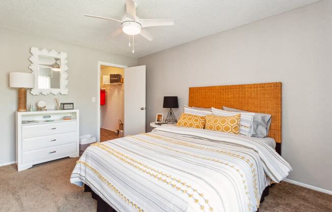 a bedroom with a large bed and a ceiling fan