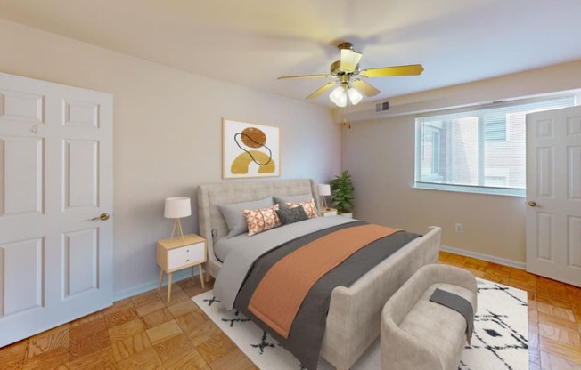 a bedroom with a bed and a ceiling fan at halley house apartments in washington dc