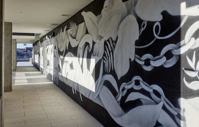 A long hallway with a black and white mural on the wall.