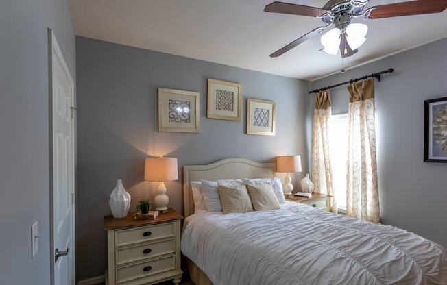 a bedroom with a bed and a ceiling fan