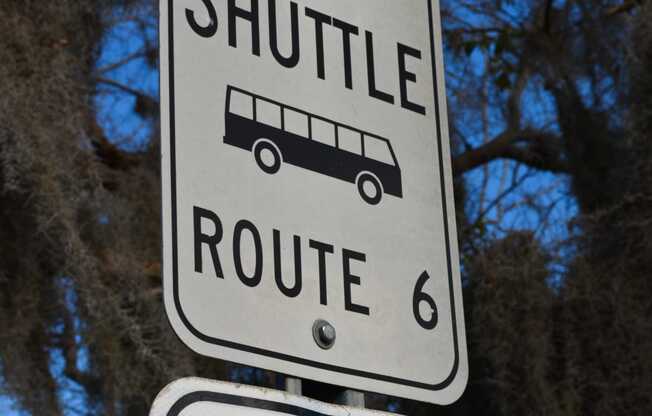 a street sign that reads shuttle route 6 and stop 2
