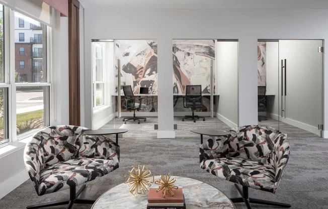A modern living room with a large window, two chairs, a coffee table, and a book titled "Sexuality in the Bible.".