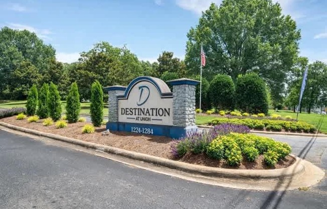 A sign for Destination at Union with a phone number and a flag.