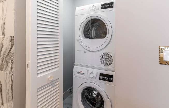a small laundry room with a washing machine and a dryer