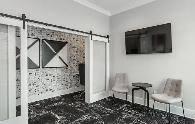 a living room with two chairs and a sliding barn door