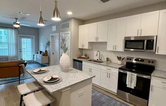 A kitchen with a white countertop and a stove top oven.