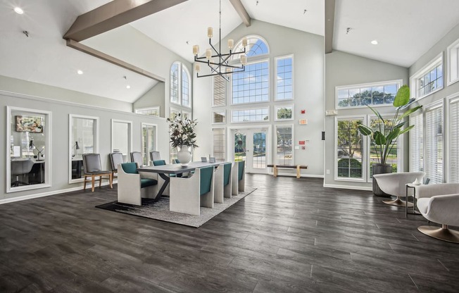 A large, well-lit room with a dining table and chairs.