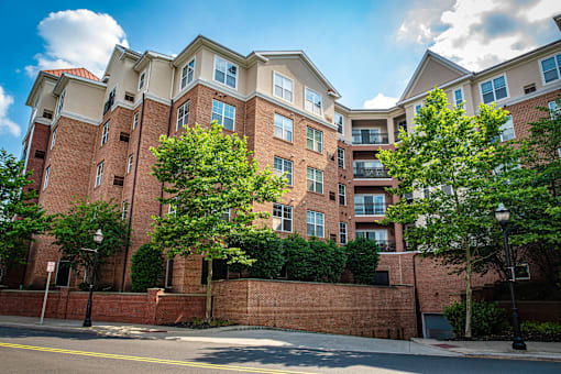 a red brick apartment building with trees in front of it