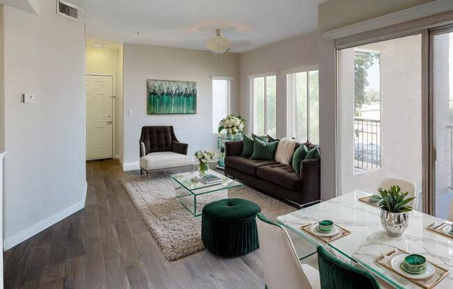 a living room and dining room with a table and chairs