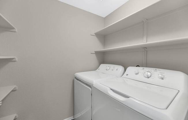 A white washing machine and dryer in a small laundry room.