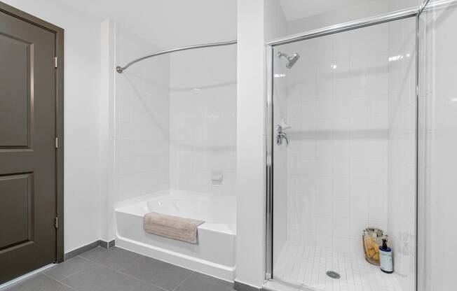 a white bathroom with a shower and a tub