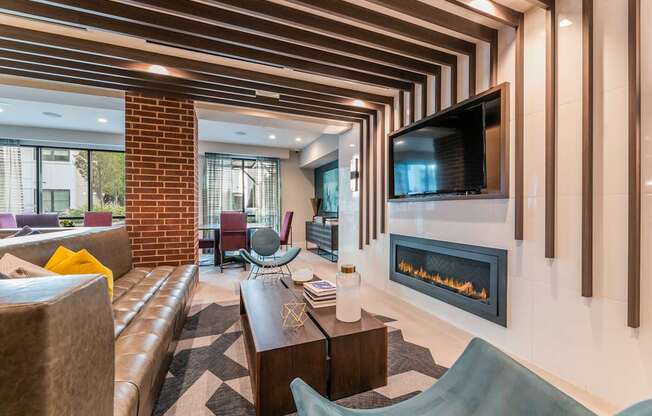 A modern living room with a fireplace and a television.