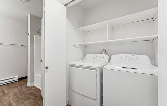 A small laundry room with a washer and dryer.