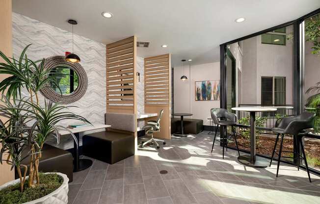 A modern living room with a grey floor and a large mirror on the wall.