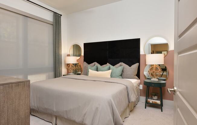 Bedroom with cozy bed at The Flats at West Alabama, Houston, TX