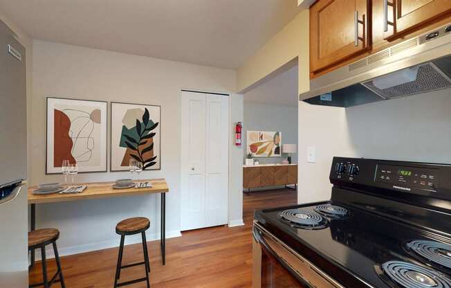 a kitchen with a stove and a counter with stools