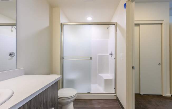 a bathroom with a toilet sink and shower