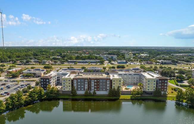 an aerial view of apartment buildings near a body of water