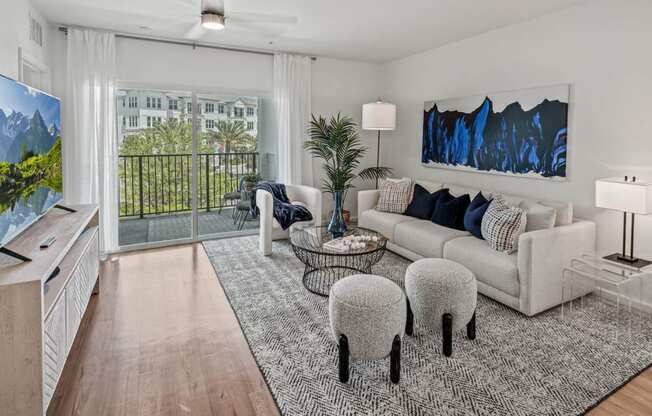 a living room with a couch and a tv at Altis Grand Lake Willis, Orlando Florida 