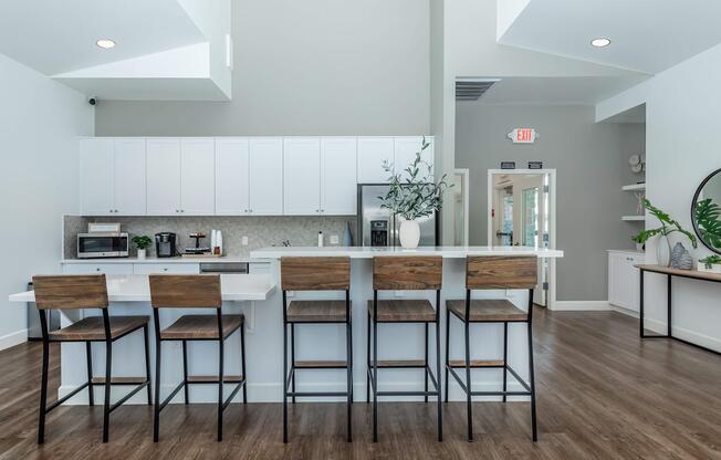 a kitchen with a table and chairs in a room