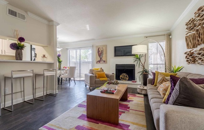 A living room with a fireplace and a couch.at 2400 Briarwest Apartments, Texas, 77077