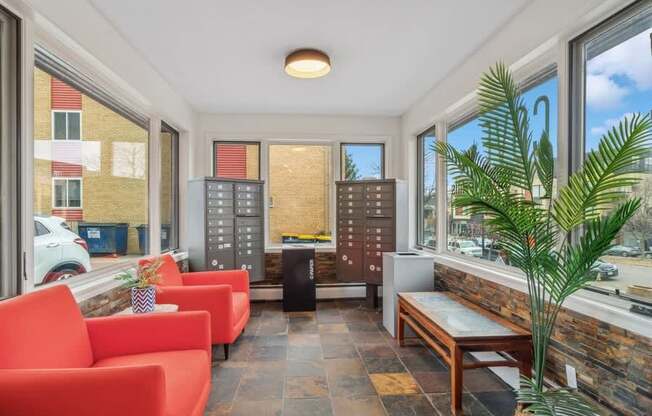 A room with red chairs and a wooden bench.