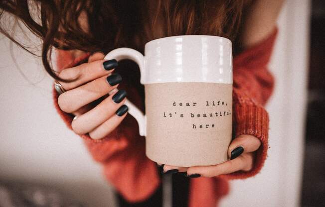 a woman holding a cup in her hands