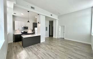 A spacious kitchen with a bar area and a dining table.