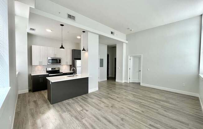 A spacious kitchen with a bar area and a dining table.