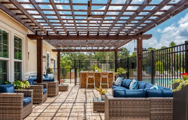 The picnic area with pergola, tiki bar, and chairs at the Flats at Sundown in North Port, Florida