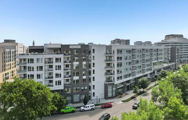 A street view of a residential area with cars and buildings.