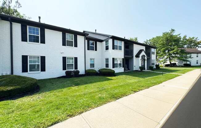 A row of white houses with black shutters.