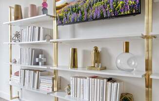 a bookshelf with a picture of a field of flowers on it