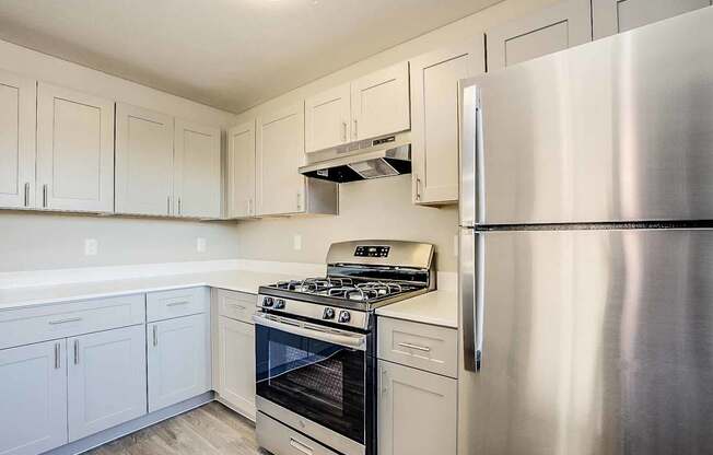 A kitchen with white cabinets and a stainless steel refrigerator at Sterling Point Apartment Homes, Phoenix, AZ