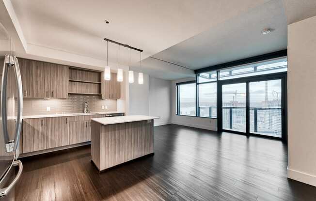 Wood plank flooring throughout the open layouts create a flexible living space at Cirrus, Seattle, Washington