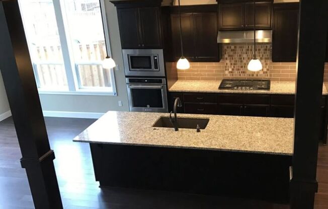 Stylish 5-Bedroom Home with Modern Kitchen, Stone Fireplace & Luxurious Primary Suite