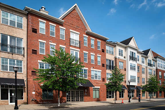 a brick apartment building on a city street at Park Square Apartments, Rahway, New Jersey