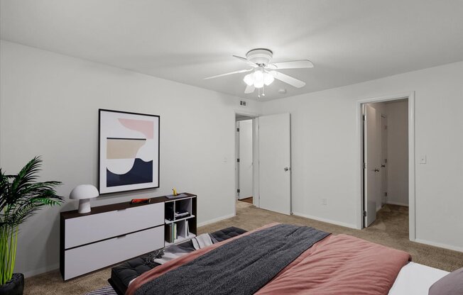 a bedroom with a bed and a ceiling fanat Millcreek Woods Apartments, Olathe