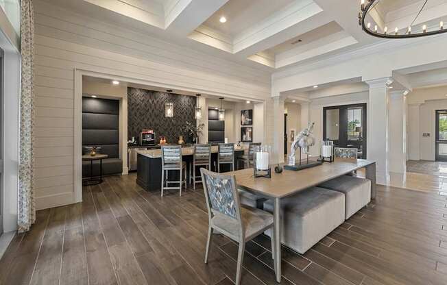 A modern dining room with a wooden floor and a large table with chairs.