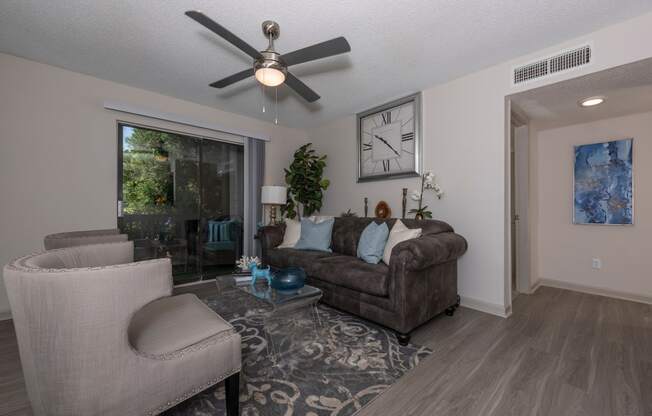 a living room with a ceiling fan and a couch