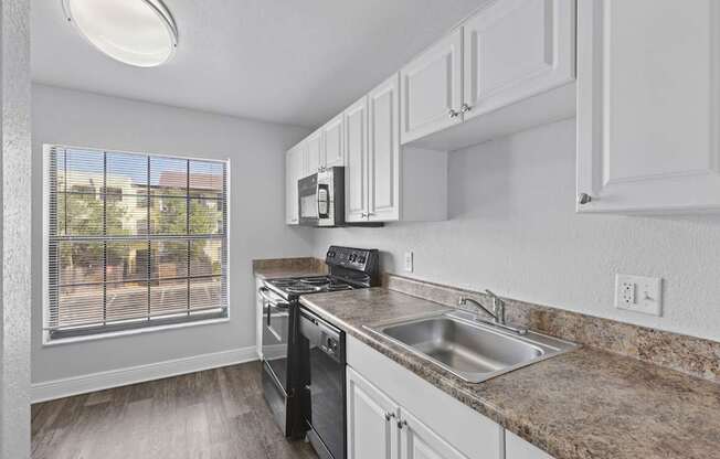 A kitchen with a stove, oven, and microwave.
