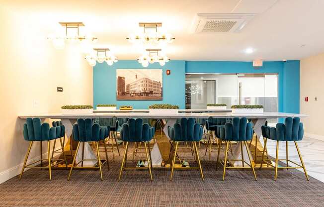 a long table with chairs in a room with a blue wall