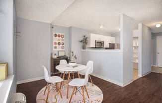 A kitchen with a table and chairs in the middle of the room.
