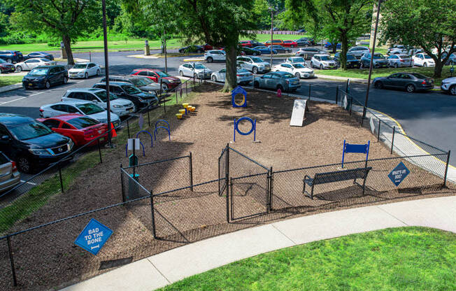 a playground in a park with cars parked in a parking lot at Parkview Towers, Collingswood, NJ