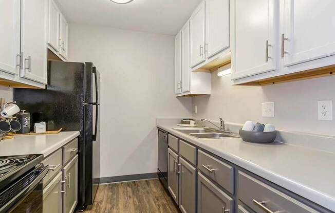 a kitchen with a stove top oven next to a refrigerator  at Renew Madison, Madison, 53711