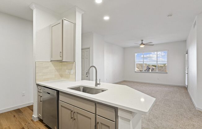an empty kitchen with a sink and a window at The Legends at Eagle Mountain Lake, Texas, 76179